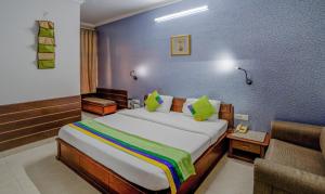 a hotel room with a bed and a couch at Treebo Bliss in Jaipur