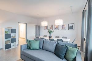 a living room with a blue couch and a table at Arbio Monteurzimmer in Wustermark Parking included in Wustermark