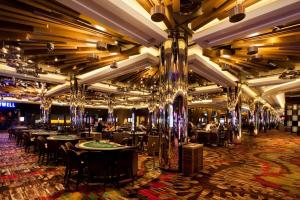 a dining room with tables and chairs and chandeliers at Breathtaking Views 49th floor - Melbourne Square in Melbourne