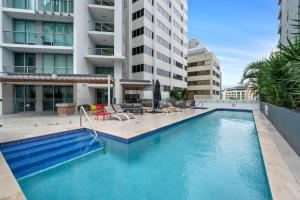 a large swimming pool in the middle of a building at City Living - Brisbane River-View 2 bedroom Apt in Brisbane