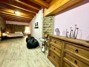 a room with a bedroom with a dresser and a bed at La casa de Claverol in Claverol
