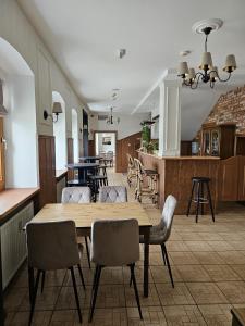 a dining room and kitchen with a table and chairs at Zajazd Zamkowy - Schloßgasthof in Krąg +65 photos
