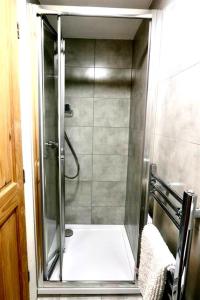 a shower with a glass door in a bathroom at 3 Bedroom Prime Angel Location in London