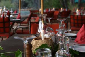 a table with a candle in a glass vase on it at Epupa Camp in Epupa