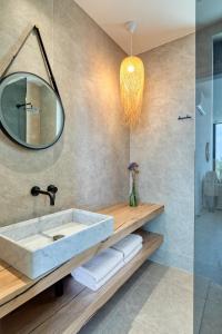 a bathroom with a sink and a mirror at 'S CAVE VILLAS SEASIDE KARYSTOS in Karistos