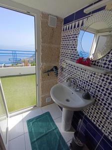 a bathroom with a sink and a large window at Apartamento Atlantico in Santa Cruz de Tenerife