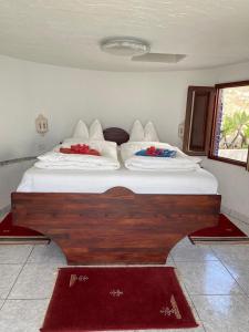 a bedroom with a large bed with two pillows at Apartamento Atlantico in Santa Cruz de Tenerife