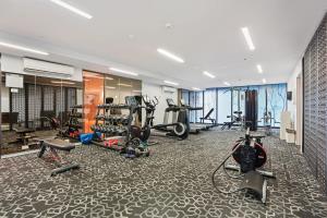 a gym with several treadmills and exercise bikes at Grosvenor on Queens Luxury Melbourne CBD Apt in Melbourne
