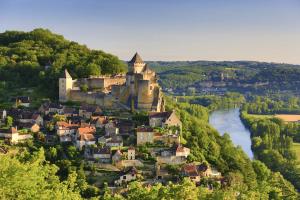 a town on a hill with a castle and a river at PRIVATE POOL with Stunning Views of the Chateau!! Old Barn in Rouffignac Saint-Cernin