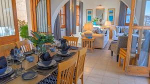 a dining room with a table and chairs at Villa Koumos - Crete Holidays With Pool and Views in Gavalochori