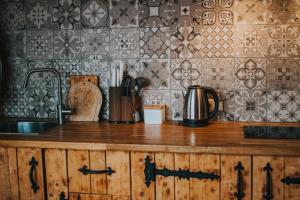 a kitchen with a counter with a sink and a counter top at Brīvdienu māja Straumēni in Pāle