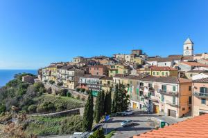 a town on a hill with a clock tower at Liù in Capoliveri