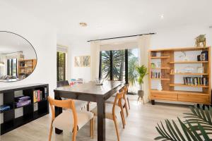 a dining room with a table and chairs at Deluxe Family Montpellier Gardens Estate - Burwood in Burwood