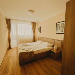 a bedroom with a bed and a window at Hizha Martsiganitsa in Asenovgrad