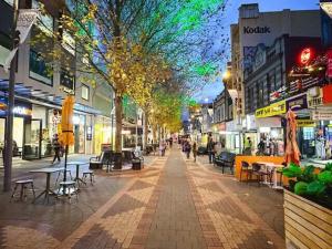 a city street with people walking down the street at Heritage Building Penthouse CBD Apartment in Hobart