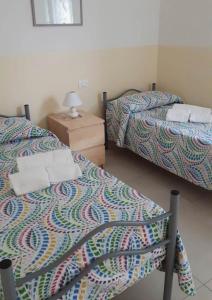 A bed or beds in a room at Casa Vacanza MariaTeresa