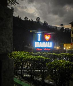 a sign that says i heart malawi at night at Oski Inn in Manāli