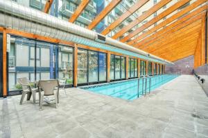 a swimming pool with a table and chairs in a building at Spacious&Cozy 2 bedroom City Point Melbourne Apt in Melbourne