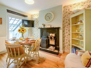 a dining room with a table and a fireplace at 2 Bed in Milford Haven 88529 in Milford Haven
