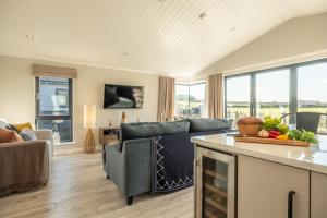 a living room with a couch and a table at 14 Westgate in Burnham Market