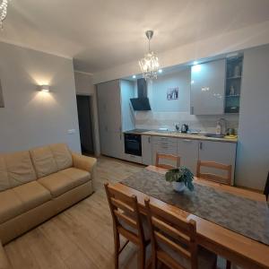 a living room with a couch and a table at Apartament Centre in Giżycko