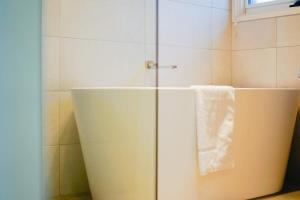 a bathroom with a white towel hanging on a refrigerator at Relaxed at Rosebud-Cosy 3 bedroom beach escape* in Rosebud +9 photos