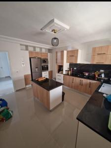 a large kitchen with a island in the middle at Belle villa Zarzis in Zarzis