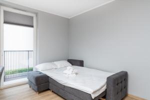 een slaapkamer met een bed en een raam bij Bronowice Comfy Studio in Krakau