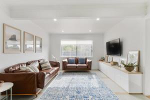 a living room with a couch and a tv at Rye Getaway - Well Appointed & Cozy Family Home* in Rye