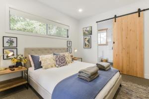 a bedroom with a large bed and a window at Rye Getaway - Well Appointed & Cozy Family Home* in Rye