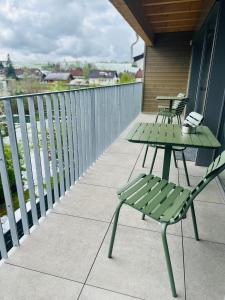 a patio with two tables and chairs on a balcony at Berg Fux - Ferienwohnung Louis der Fux in Sonthofen