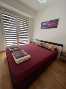a bedroom with a large bed with towels on it at Golden Lux Apartments in Skopje