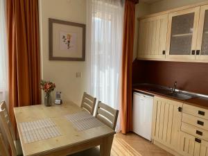 a kitchen with a table and a sink and a table and chairs at Pirin Golf private studio in Razlog