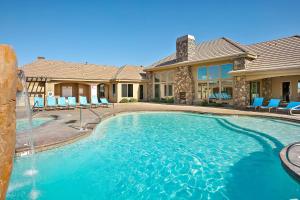 a swimming pool with a fountain in front of a house at Sunset on the 5th in Washington