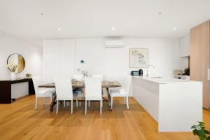 a kitchen and dining room with a table and chairs at Victoria Square - Central Footscray InnerUrban Apt in Melbourne