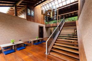 a staircase in a building with benches and a stair case at Athita The Hidden Court Chiang Saen Boutique Hotel SHA Plus CERTIFIED in Chiang Rai