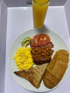 a plate of breakfast food with eggs eggs bacon and toast at Maphuthi River Lodge in Ga-Manapane