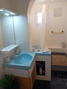 a bathroom with a blue sink and a tub at Bas de villa proche plages et calanques in Marseille +22 photos