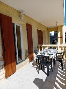 a table and chairs sitting on a patio at Bas de villa proche plages et calanques in Marseille