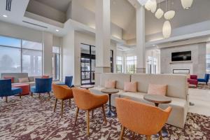 a lobby with a couch and chairs and tables at Hilton Garden Inn Indianapolis Northwest in Indianapolis