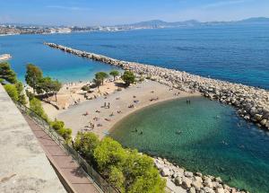 an aerial view of a beach with people in the water at Bas de villa proche plages et calanques in Marseille
