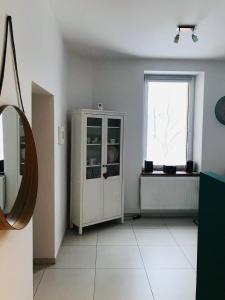 Cette chambre comprend une armoire blanche et une fenêtre. dans l'établissement Przestronne mieszkanie w centrum Chorzowa, à Chorzów