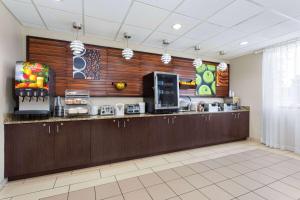 a kitchen with a counter in a room at La Quinta by Wyndham Bonita Springs Naples North in Bonita Springs