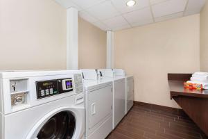 a laundry room with a washer and dryer at La Quinta by Wyndham Bonita Springs Naples North in Bonita Springs