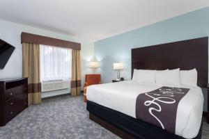 a hotel room with a bed and a television at La Quinta by Wyndham Bonita Springs Naples North in Bonita Springs