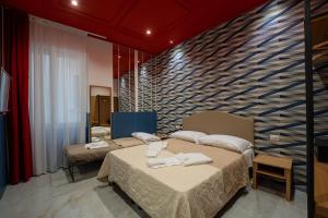 Posteľ alebo postele v izbe v ubytovaní Medina H. Napoli Centro, by ClaPa Group