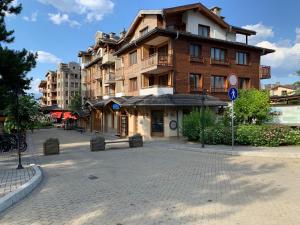 a large building on a street in a city at Pirin Golf private studio in Razlog