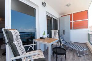 a room with a table and chairs and a balcony at Comodoro 6 - One Bed in Los Cristianos