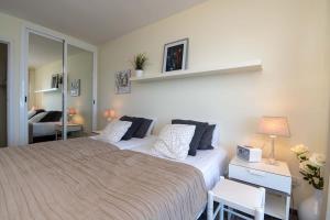 a bedroom with a large bed and a mirror at Comodoro 6 - One Bed in Los Cristianos