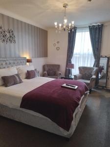 a bedroom with a large bed and a living room at Sunflower Lodge in Bridlington